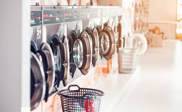 Laundry machines with baskets in front